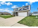 Beautiful home featuring a brick facade, a well-kept lawn and a two car driveway at 8961 Fitzgerald Dr, Indianapolis, IN 46239