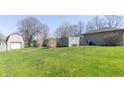 A spacious backyard with a lush green lawn, shed, and wood fence at 918 N 700 W, Greenfield, IN 46140