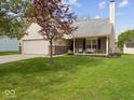 Charming brick home with a cozy front porch and manicured landscaping, perfect for relaxing outdoors at 936 Eagle Brook Cir, Shelbyville, IN 46176