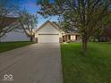 Inviting single-Gathering home with a two-car garage and a well-maintained lawn at 936 Eagle Brook Cir, Shelbyville, IN 46176