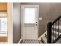 Bright entryway featuring neutral walls, decorative lighting, and stair access to the upper levels at 9609 Highgate N Cir, Indianapolis, IN 46250