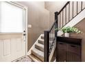 Neutral entryway featuring stairs with dark banister and access to upper levels at 9609 Highgate N Cir, Indianapolis, IN 46250