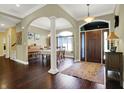 Inviting foyer showcasing hardwood floors, an arched entryway, and natural light at 9879 Ruby Ct, Mooresville, IN 46158