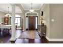 Elegant foyer featuring hardwood floors, decorative columns, and a stylish front door at 9879 Ruby Ct, Mooresville, IN 46158