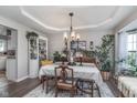 Inviting dining room features stylish decor, tray ceiling, and lots of natural light at 10518 Greenway Dr, Fishers, IN 46037