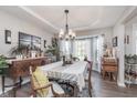Bright dining room boasts large windows, elegant lighting, and beautiful furnishings at 10518 Greenway Dr, Fishers, IN 46037