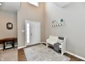 Bright foyer with a soaring ceiling, decorative rug, white bench, and wooden floors at 1291 Timber Bluff Rd, Westfield, IN 46074