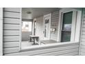Covered front porch with a view of the entryway featuring seating area and covered entryway at 1303 S Shipley St, Muncie, IN 47302