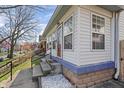 Side view of a charming home with a porch and well-maintained landscaping at 1417 Sturm Ave, Indianapolis, IN 46201