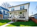 Charming two-story home with a welcoming front porch, manicured lawn, and inviting curb appeal at 1603 E Market St, Indianapolis, IN 46201