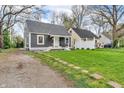 Cozy single Gathering home with a gravel driveway and spacious front lawn at 1621 E 44Th St, Indianapolis, IN 46205