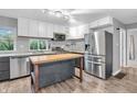 Modern kitchen features stainless steel appliances, butcher block island and white cabinets at 1621 E 44Th St, Indianapolis, IN 46205