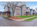 Scenic street view of attractive blue townhouses with inviting porches at 1635 N College Ave # 5, Indianapolis, IN 46202