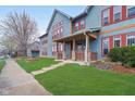Well-kept home exterior featuring a welcoming front porch, stone pillars, and green lawn at 1635 N College Ave # 5, Indianapolis, IN 46202