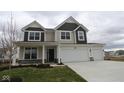 Two-story home featuring a two-car garage, covered porch, and neutral color palette at 17026 Cowbell Dr, Noblesville, IN 46060