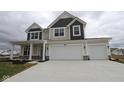 Two-story home featuring a two-car garage, covered porch, and neutral color palette at 17026 Cowbell Dr, Noblesville, IN 46060