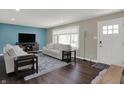 Well-lit living room with plush seating, area rug, large window, and contemporary decor at 1750 W Stop 11 Rd, Indianapolis, IN 46217