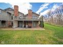 Two-story home with a deck, covered patio, and well-maintained lawn at 206 Somerville Rd, Anderson, IN 46011