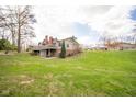 Large yard, showcasing the deck and rear of the house at 206 Somerville Rd, Anderson, IN 46011