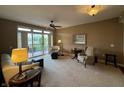 Bright living room features a ceiling fan and a sliding glass door to the outside at 20971 Shoreline Ct # 214, Noblesville, IN 46062