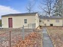 The home's rear exterior features a fenced backyard and a walkway, with the house displaying yellow siding at 2260 N Graham Ave, Indianapolis, IN 46218