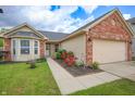 Attractive home featuring a well-maintained lawn, blooming roses, and a two-car garage at 2390 Lakecrest Dr, Columbus, IN 47201