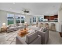 Open-concept living room featuring a plush rug, gray sofa, and seamless flow into the kitchen and a breakfast bar at 2859 Dursillas Dr, Plainfield, IN 46168