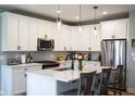 Stylish kitchen featuring white cabinets, stainless appliances, and a center island with seating at 2932 Camden Ct, Greenwood, IN 46143