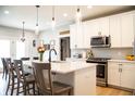 Bright, modern kitchen with white cabinets, stainless steel appliances, and quartz countertops at 2932 Camden Ct, Greenwood, IN 46143