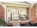 Inviting front porch with decorative plants, bench seating, and stylish lanterns at 3165 Hazel Foster W Ct, Carmel, IN 46033