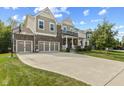 Spacious two-story home with three car garage, inviting covered porch, and long driveway at 4285 Nottinghill Dr, Avon, IN 46123