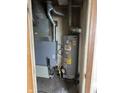 Close-up view of the furnace and water heater, indicating the home's essential systems at 5810 Greenfield Ave, Indianapolis, IN 46219
