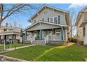 Inviting two-story home with a classic front porch, perfect for enjoying the outdoors at 601 Wallace Ave, Indianapolis, IN 46201