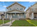 Charming two-story home featuring a welcoming front porch and classic architectural details at 601 Wallace Ave, Indianapolis, IN 46201
