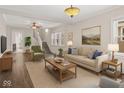 Bright living room with hardwood floors, a neutral color palette, and a staircase at 601 Wallace Ave, Indianapolis, IN 46201