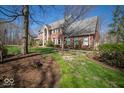 Beautiful two-story red brick home with manicured lawn and driveway at 6013 Yellow Birch Ct, Avon, IN 46123