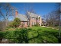 A beautiful red brick home with a well-manicured lawn on a sunny day at 6013 Yellow Birch Ct, Avon, IN 46123