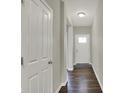 Hallway features hardwood floors and a white front door with glass panel at 6026 Rockdell Dr, Indianapolis, IN 46237