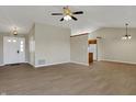 Bright open-concept living space with wood-look flooring, a ceiling fan, and view to the kitchen at 6026 Sally Ann Cir, Indianapolis, IN 46237