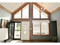 Inviting foyer features an abundance of natural light and a stylish front door with glass detailing and wood accents at 6276 Quail Rdg W Dr, Plainfield, IN 46168
