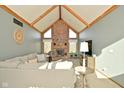 Cozy living room features a brick fireplace, vaulted ceilings, and comfortable seating for a relaxing gathering space at 6276 Quail Rdg W Dr, Plainfield, IN 46168