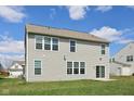 Spacious backyard featuring a well-maintained lawn and sliding door access to the house at 6681 Keepsake Dr, Whitestown, IN 46075