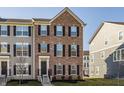 Attractive townhouse showcasing brick facade, black shutters, and a well-maintained front yard at 6953 Equality Blvd, Carmel, IN 46033
