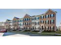 Desirable neighborhood featuring modern townhomes with brick and siding exteriors along a tree-lined street at 6953 Equality Blvd, Carmel, IN 46033