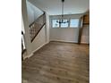 Spacious dining room with a staircase, wood-look floors, natural light from windows, and contemporary chandelier at 798 James William Ln, Westfield, IN 46074