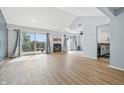 Bright living room featuring vaulted ceilings, a cozy fireplace, and sliding doors to a private balcony at 8158 Shorewalk Dr # F, Indianapolis, IN 46236