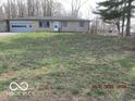 Charming stone house featuring an attached garage and a well-maintained front yard at 8625 Edith St, Martinsville, IN 46151