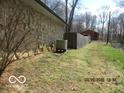 Landscaped side yard featuring a retaining wall and fencing at 8625 Edith St, Martinsville, IN 46151