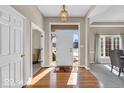 Bright foyer with hardwood floors and views into the dining and living areas at 8717 Vintner Ct, Indianapolis, IN 46256