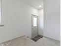 Inviting entryway features carpet, wood flooring, and a glass-paneled front door at 8745 Big Bend Rd, Martinsville, IN 46151